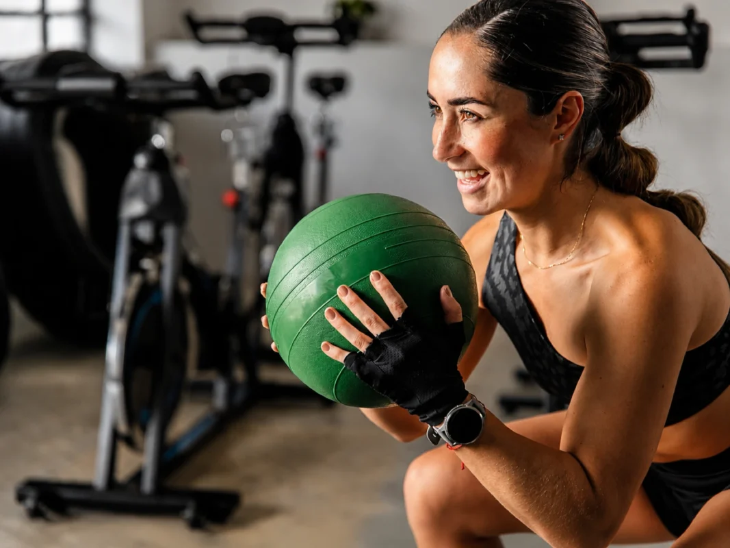 Trainer coaching a client through a squat in Oakville